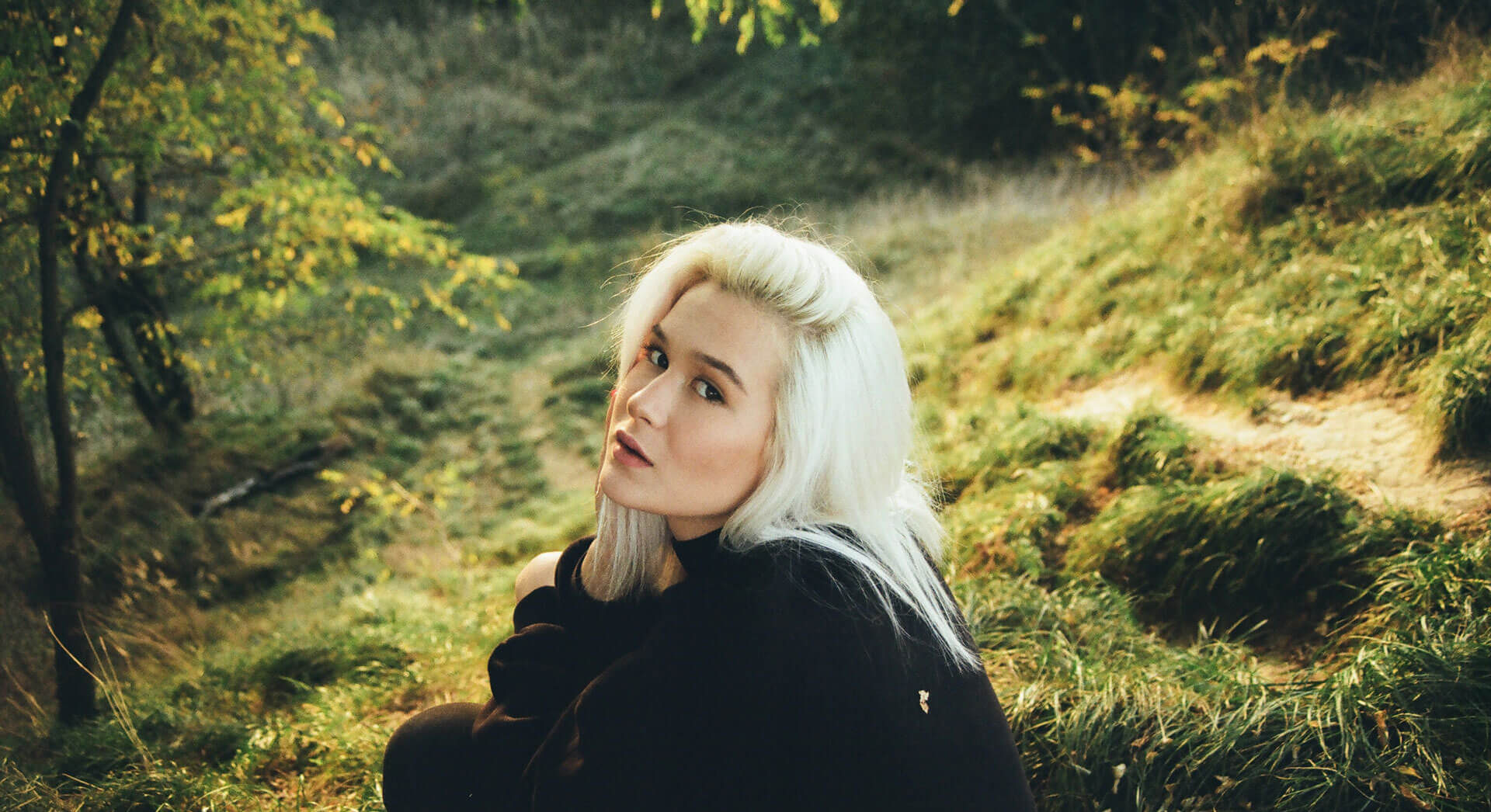 woman-in-black-long-sleeve-sweater-with-platinum-blond-hair
